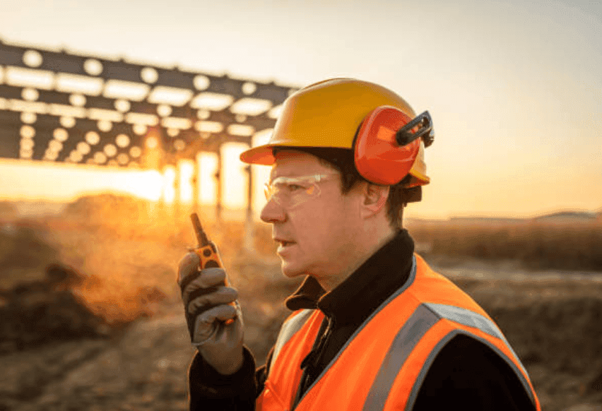 Construction worker with walkie-talkie at golden hour - understanding the business and what needs to be financed
