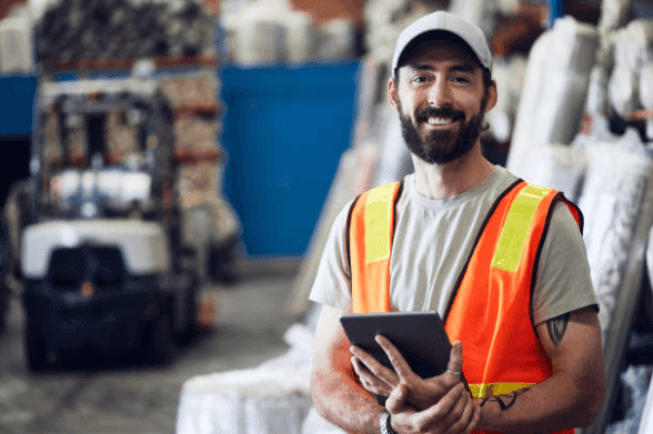 Warehouse manager reviewing options on a tablet - exploring suitable lender options for your business